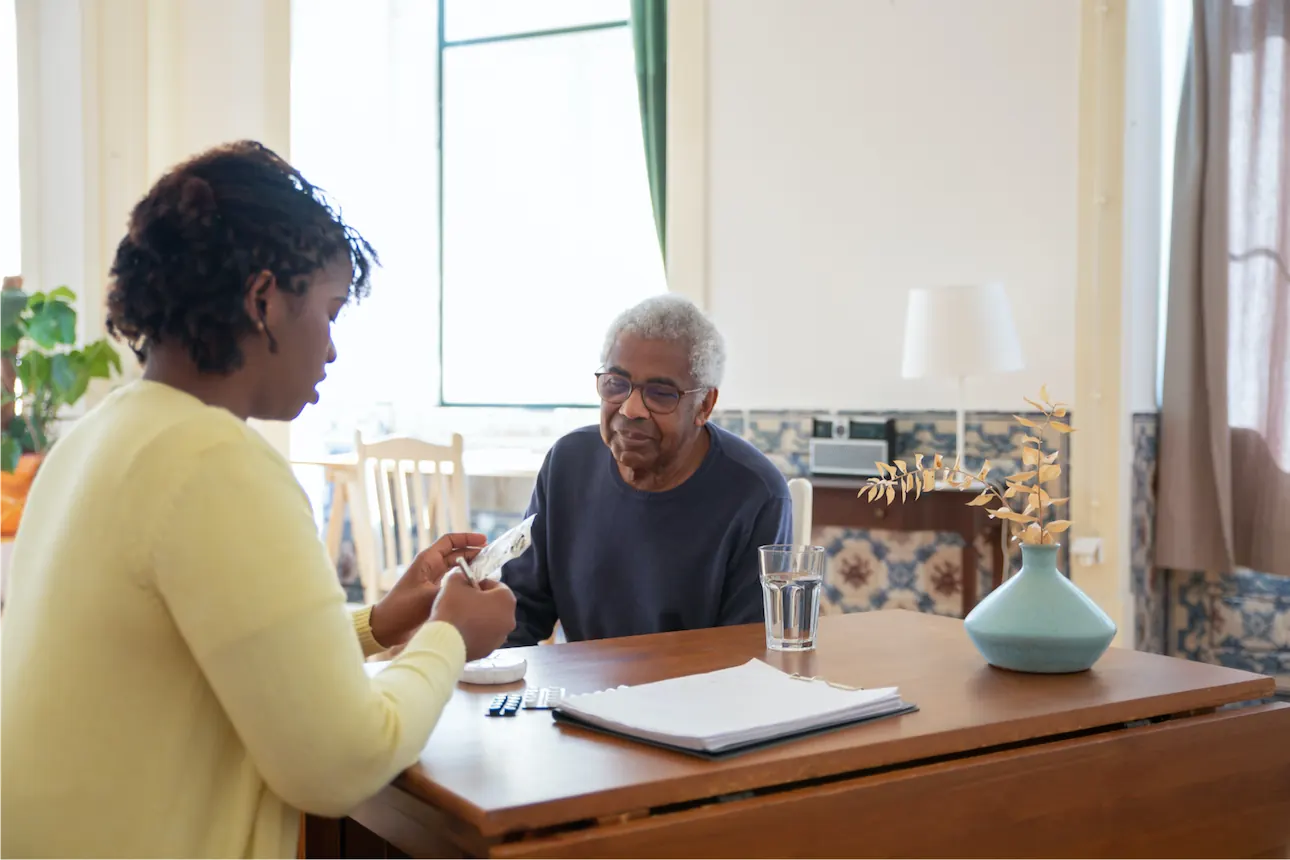 Time2Time carer visiting an elderly man at home and talking through his care plan